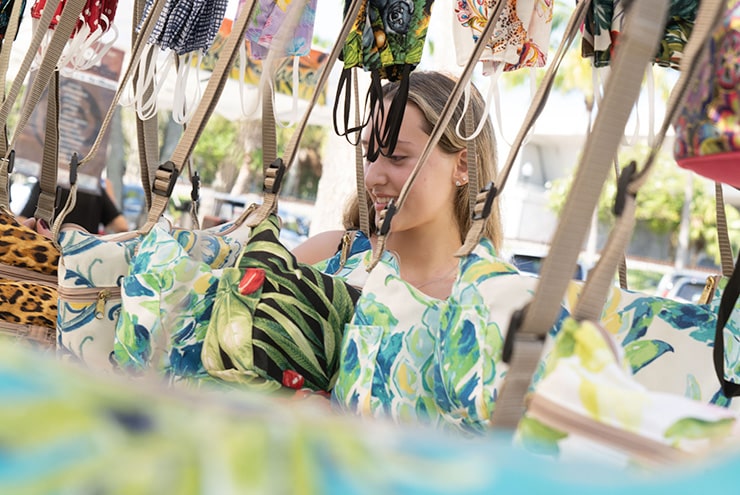 woman shopping at a booth in stuart market on main