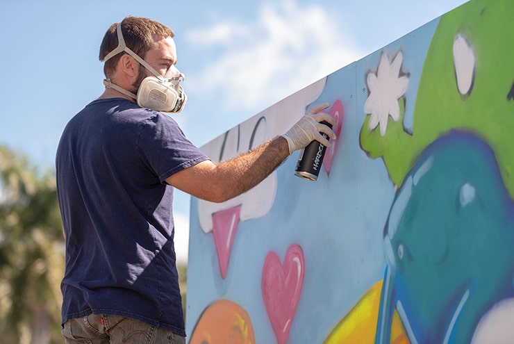 man spray painting for Stuart ArtsFest