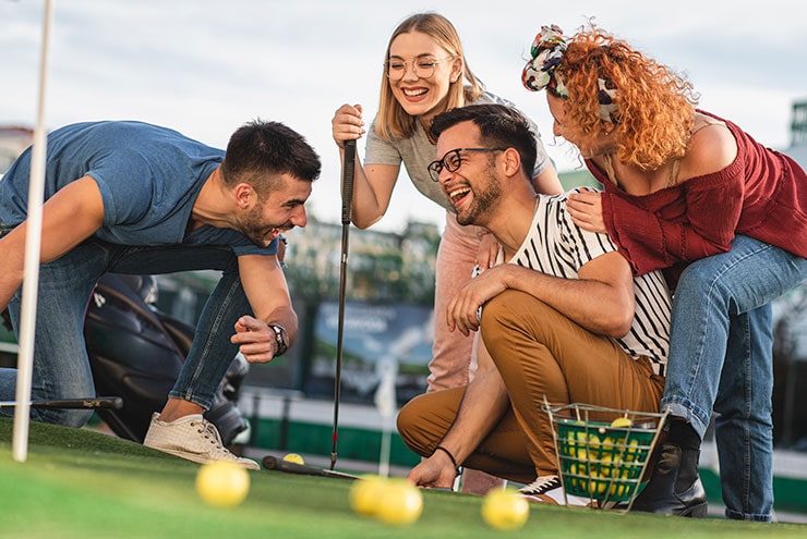 friends around balls at public martin county golf course