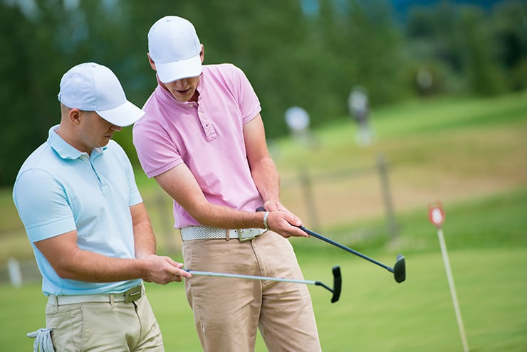 men comparing swings at semi private club